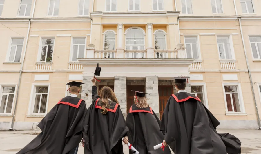 Graduates outside a university building